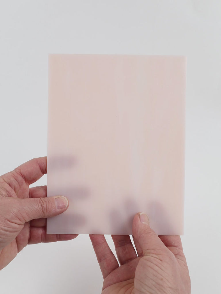 Video of the Coral glass plate in translucent pink, 15x19cm, held up and tilted to show its pattern and transparency