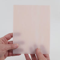 Video of the Coral glass plate in translucent pink, 15x19cm, held up and tilted to show its pattern and transparency