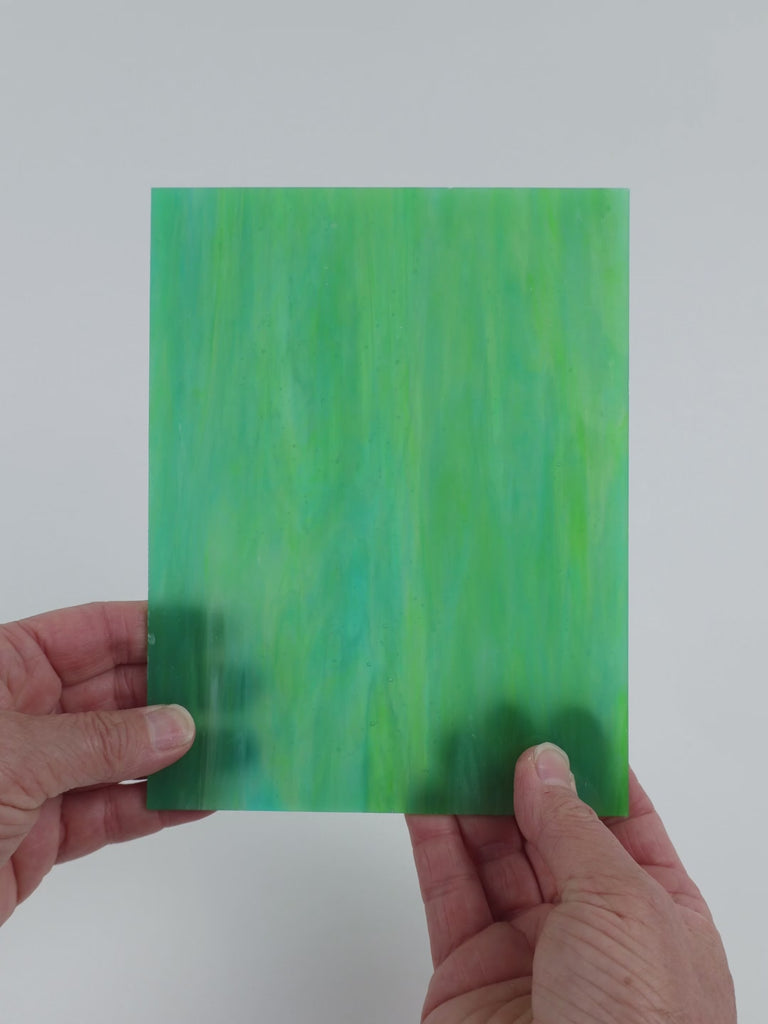 Video of the Lagoon glass plate in translucent teal, 15x19cm, held up and tilted to show its pattern and transparency