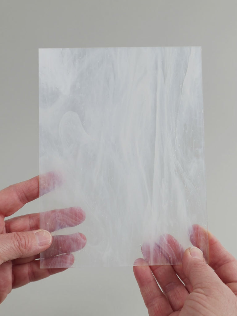 Video of the ice glass plate in semi-transparant white , 15x19cm, held up and tilted to show its pattern and transparency