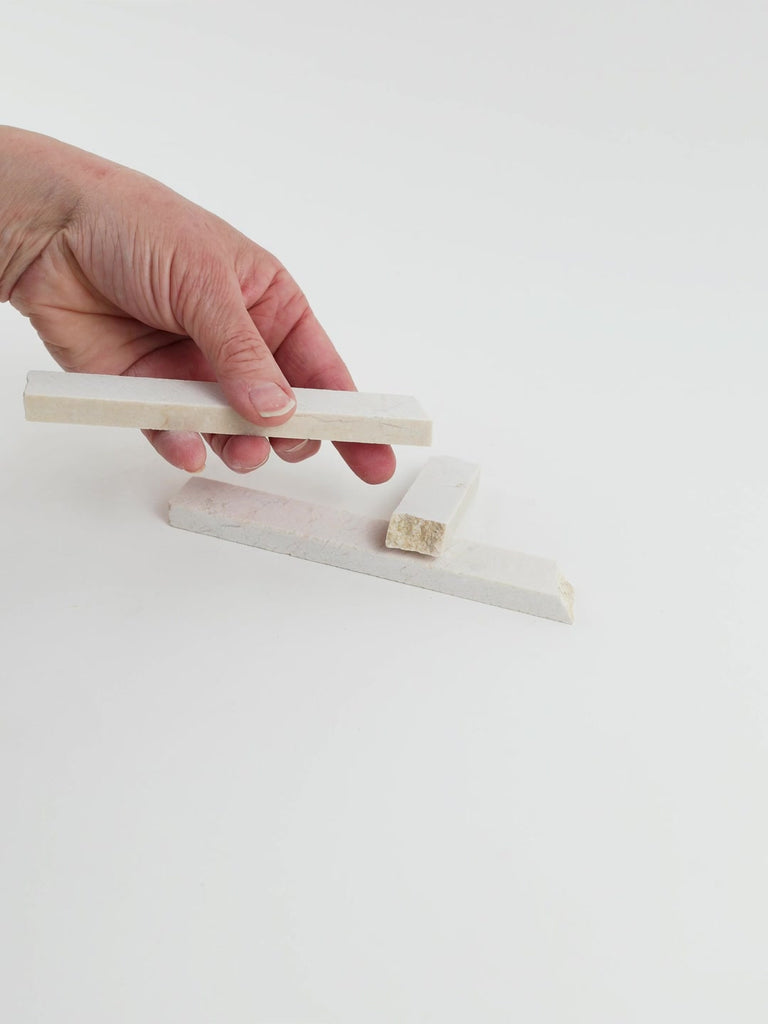 Video of Marble Bars XL Botticino in opaque cream-beige natural marble, 1–20 cm long and 8 mm thick, picked up by hand and turned to show their length, colour and natural veining