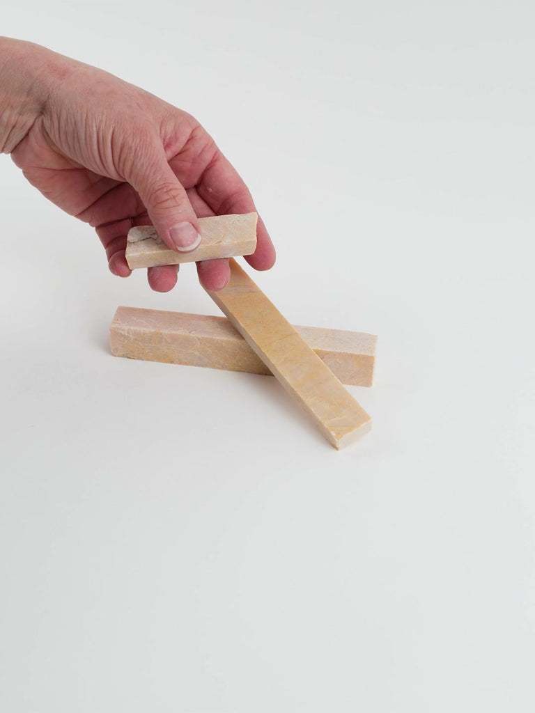 Video of Marble Bars XL Giallo Reale in opaque orange-yellow natural marble, 1–20 cm long and 8 mm thick, picked up by hand and turned to show their length, colour and natural veining