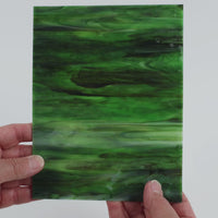 Video of the Evergreen Ripple glass plate in ripple translucent green, 15x19cm, held up and tilted to show its pattern and transparency