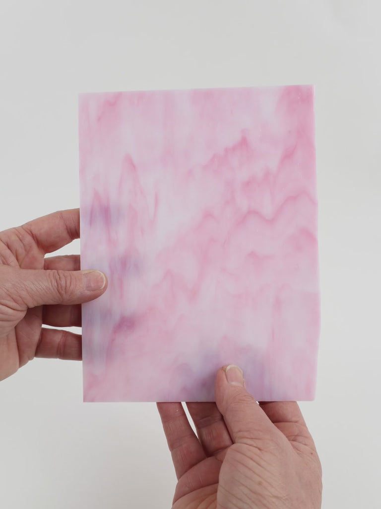 Video of the peony glass plate in translucent pink, 15x19cm, held up and tilted to show its pattern and transparency